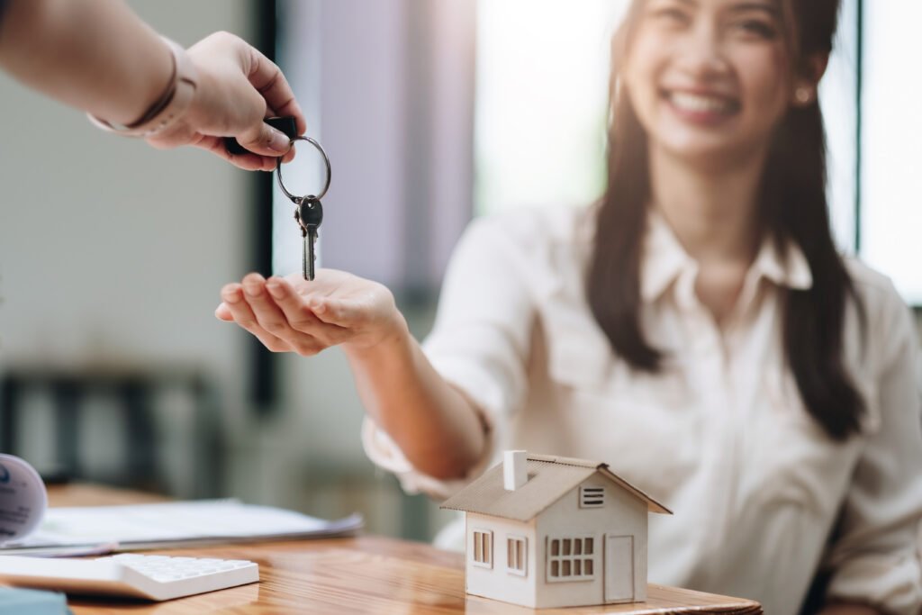Woman buying a house and receiving her home keys
